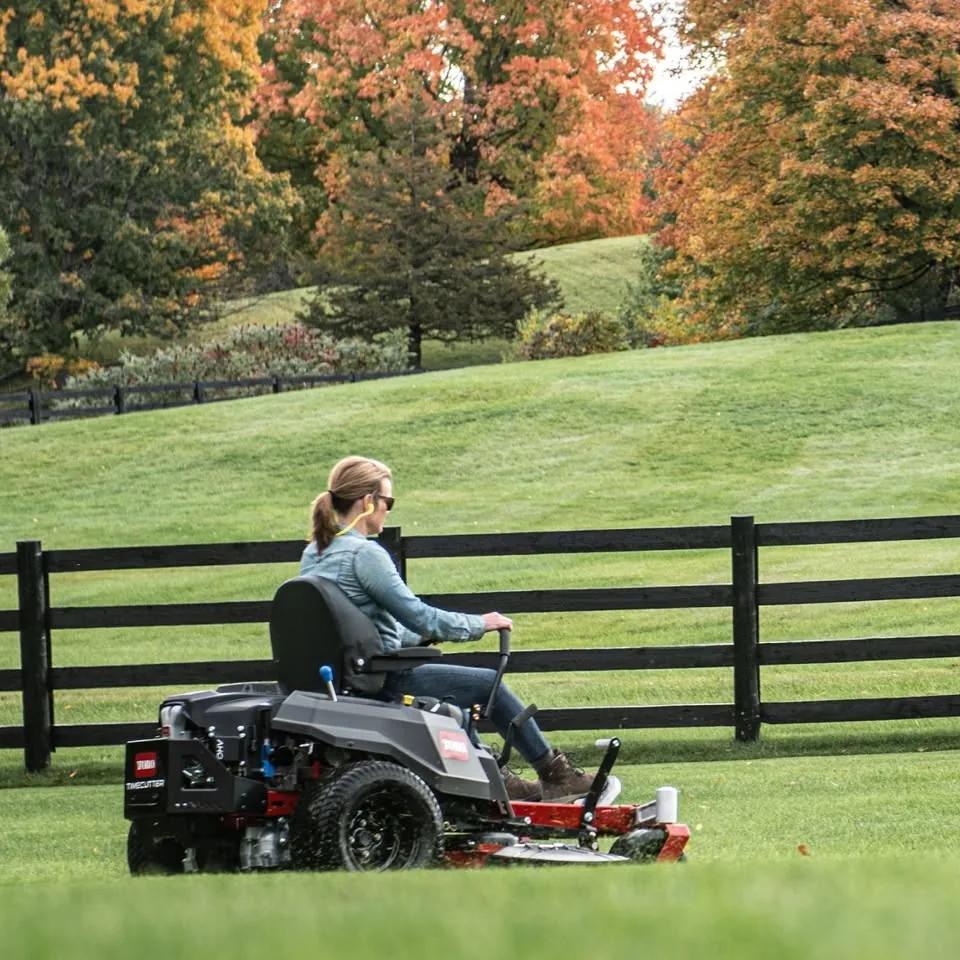 Technician servicing a red mower
